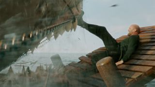 Jason Statham pushing a Megalodon back with his boot in Meg 2 The Trench.